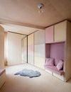 Sofa nook and double bed behind mirrored sliding door in a 13 square meter studio designed by Studiomama (Photo: Rei Moon)