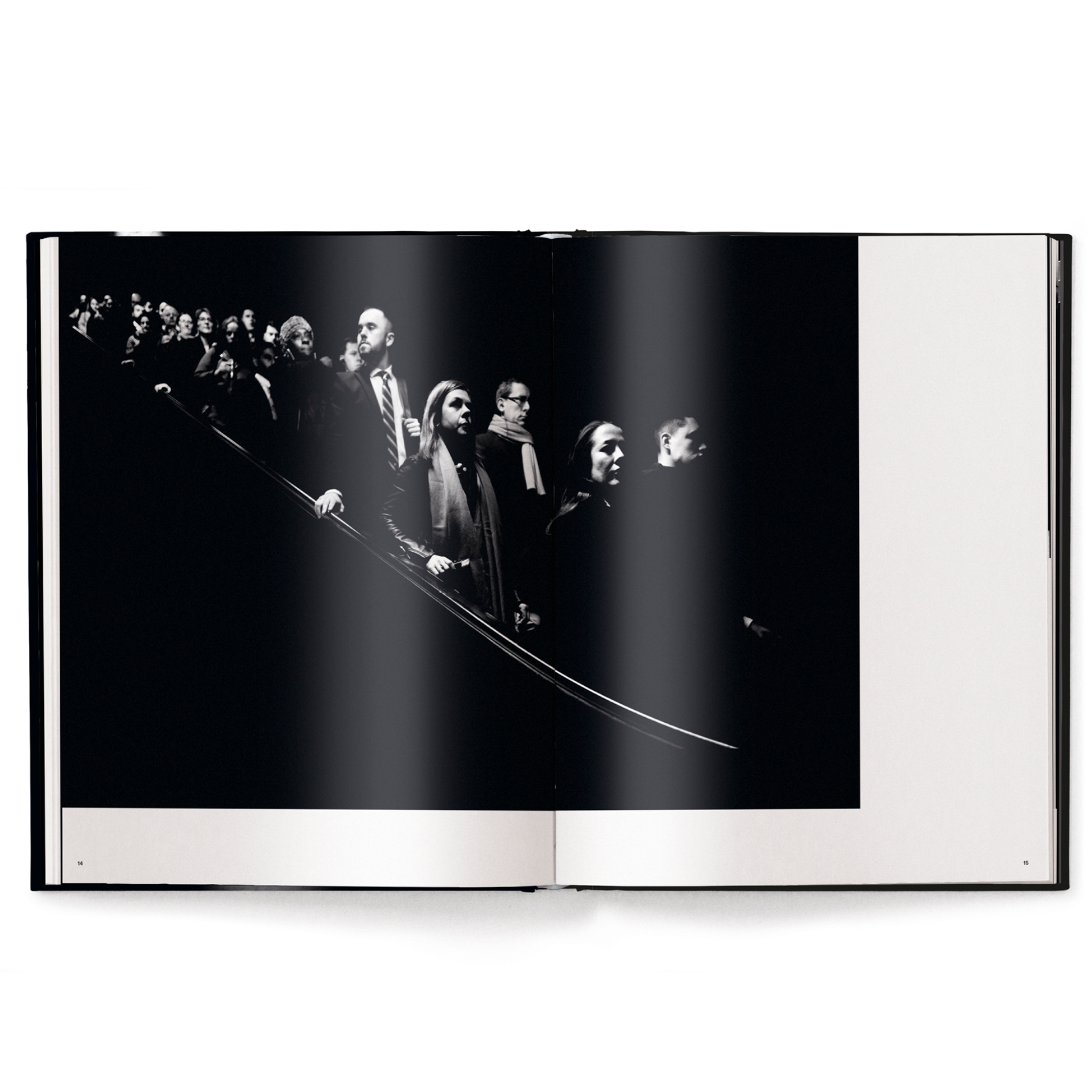 Open book showing a black and white photograph of a crowd.
