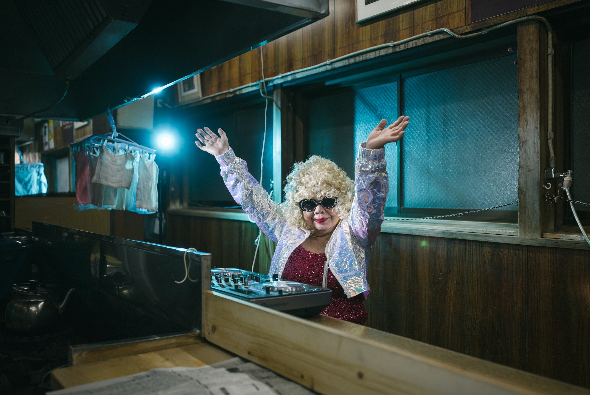 In the college district of Takadanobaba, there is a hole-in-the-wall gyoza restaurant called Muro, which was founded in 1954. If you visit, you might see an elderly woman stir-frying vegetables behind the counter, a common sight in such family-owned businesses. What you might not expect, however, is that same old woman heading out to the clubs in the evening to spin tracks for partygoers until sunrise. This is DJ Sumirock, a Tokyo club icon and, as of 2021, the oldest DJ in the world at 86 years old.