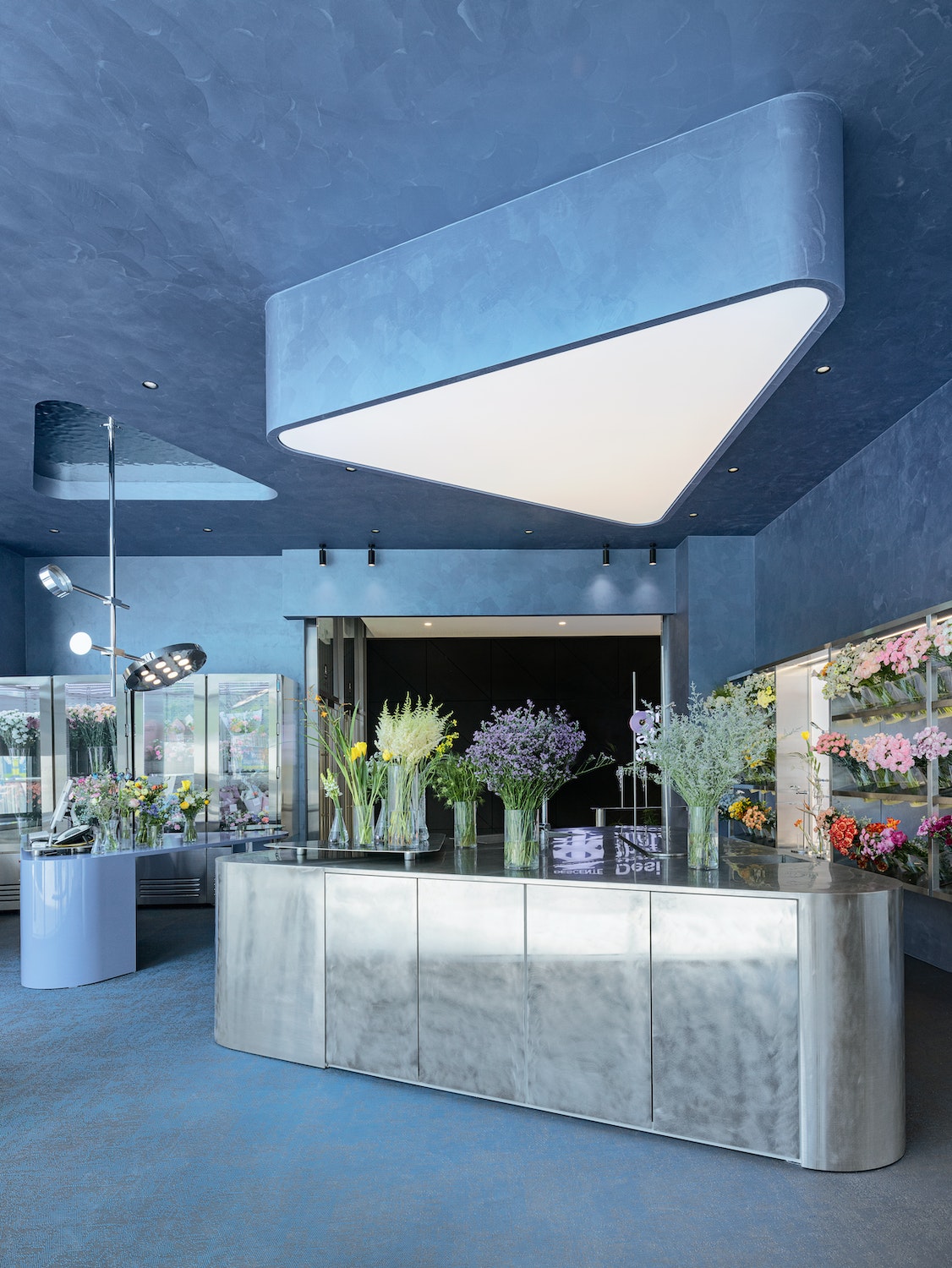 The angular stainless steel furniture and the functional lights turn the store into a laboratory. Customers become researchers, experimenting with flower combinations and their own sense of aesthetics. Find more about O’Flower, a South Korean store featured in Think Big - Shop Small.