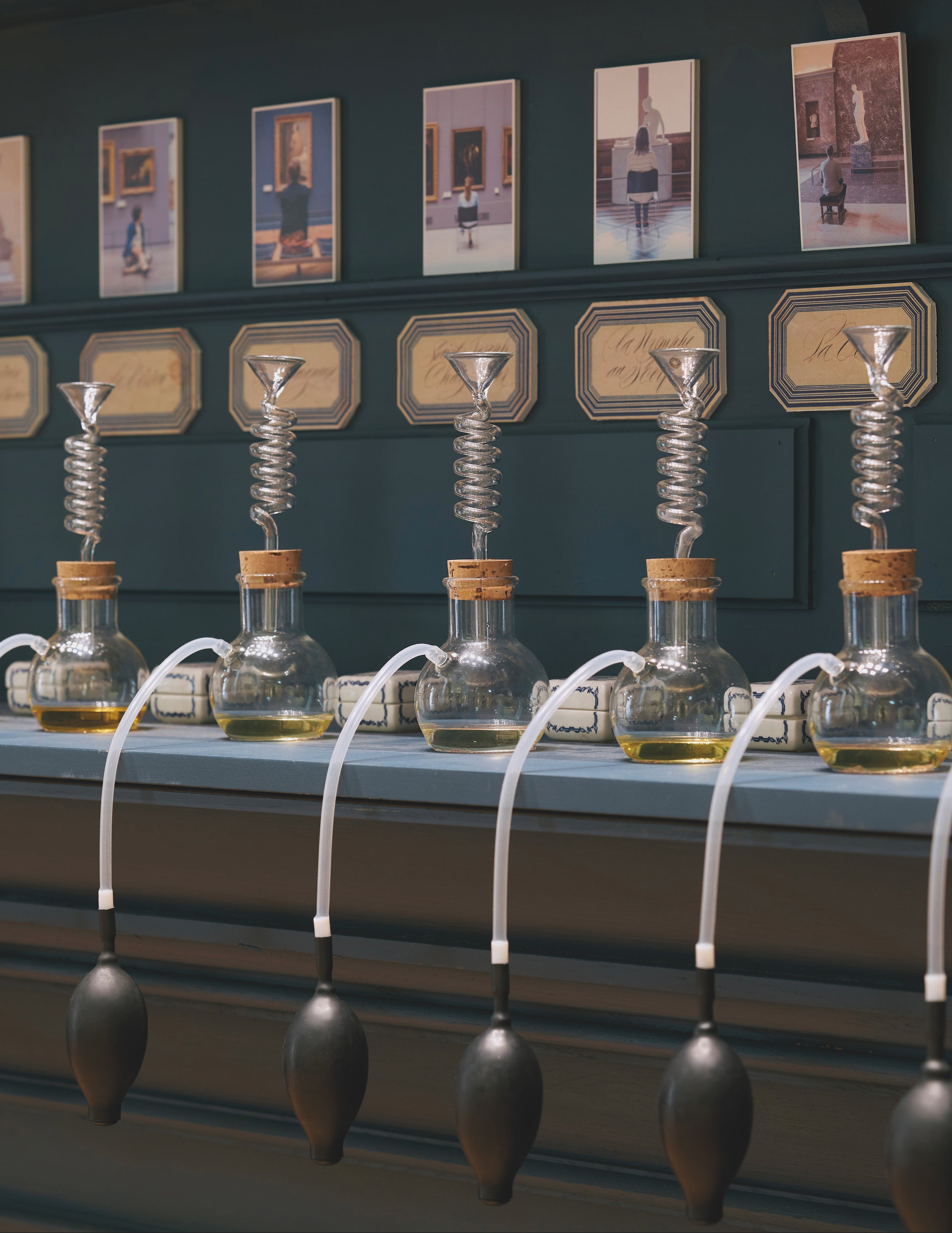 A detailed view of the perfume alembics with some alabasters, and a calligraphy display on the wall for the Louvre’s Officine. Find out more about this unique collection in The Beauty of Time Travel.