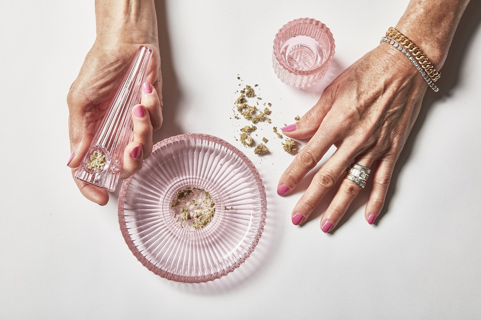 Fashioned from rose-pink ridged glass, this elegant three-piece set of marijuana accessories features an ashtray, grinder, and pipe in High on Design
