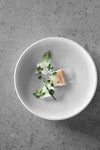 A piece of fish plated and garnished with delicate herbs. (Photo: Michael Jepsen)