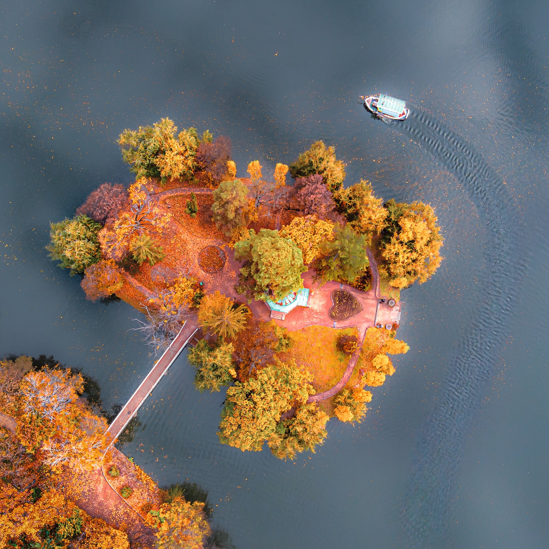 Aerial view of a colorful island with a boat on a lake