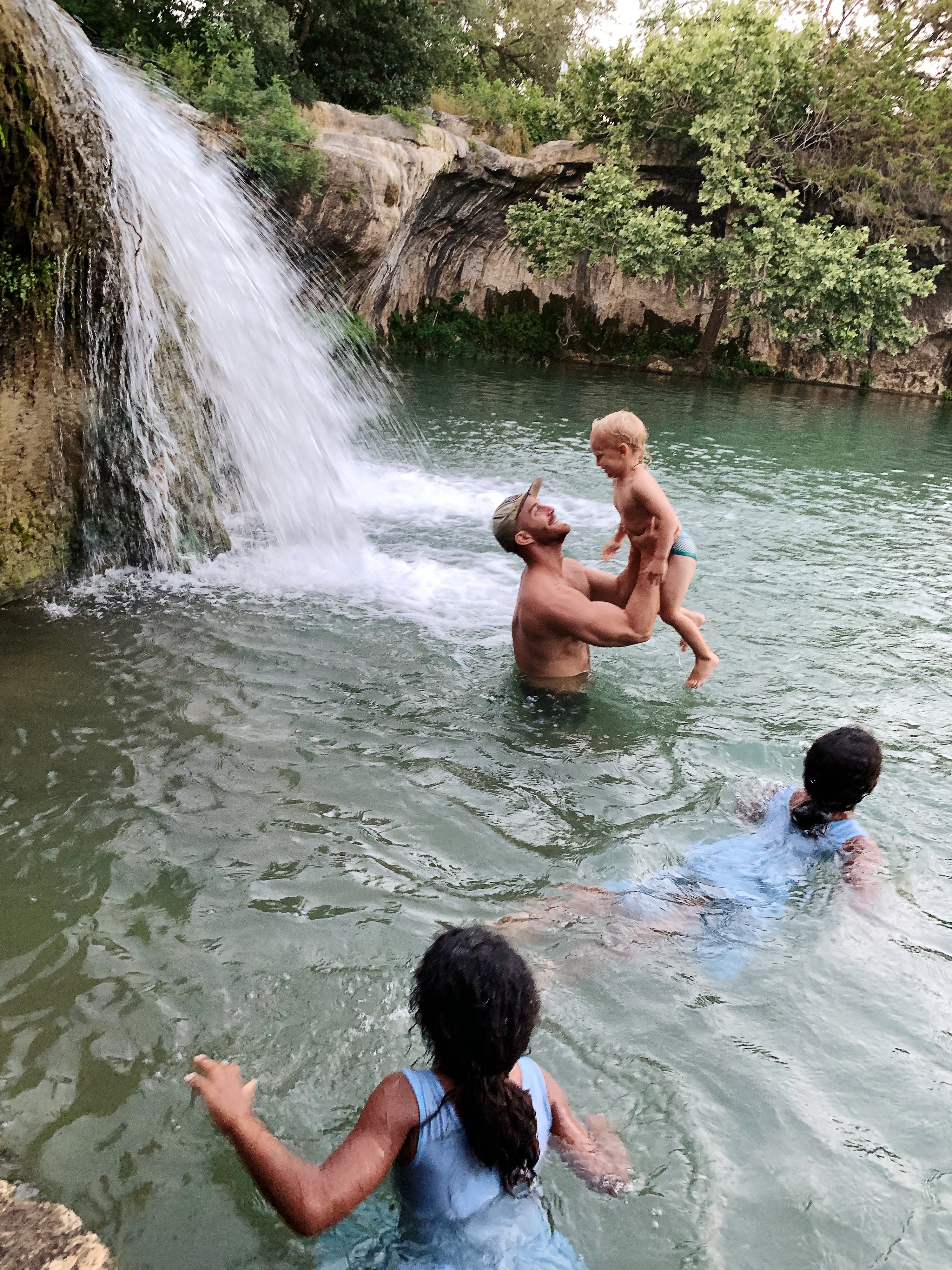 A dad and in his son in a river in Family Adventures
