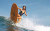 A woman surfing a wave in She Surf