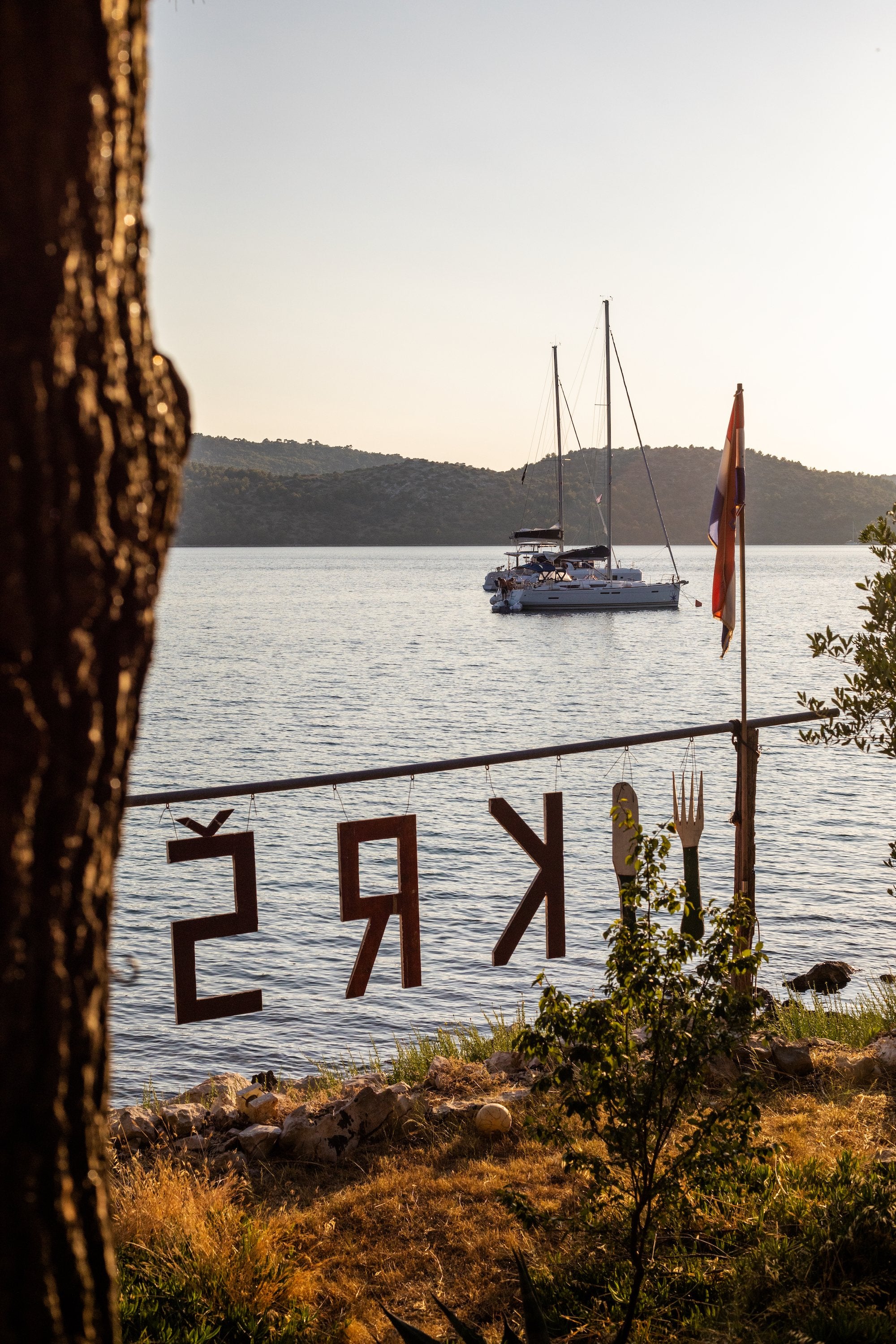 View on a creek with a sailing boat in Sailing the Seas