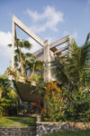 Located in a small valley on Bali’s southern coast, this geometric concrete home was designed as a collaboration between architectural studio Patisandhika and multidisciplinary designer Daniel Mitchell. Inspired by the American architect Ray Kappe, the L-shaped structure blurs the divide between the indoors and outdoors. It creates a series of changing moods through a dynamic layout and material selection.