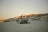 A Westfalia van on a beach in The Getaways by gestalten